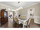 Open dining room with modern lighting, hardwood floors, and views to adjacent rooms at 2715 Ivey Crossing Trl, Cumming, GA 30041