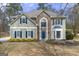 Beautiful home with stone facade, well-kept lawn, and blue shutters adds charming curb appeal at 2715 Ivey Crossing Trl, Cumming, GA 30041