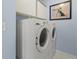 Efficient laundry room featuring modern washer and dryer units and storage cabinets at 2715 Ivey Crossing Trl, Cumming, GA 30041
