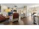 Spacious living room with hardwood floors, fireplace, and multiple windows with backyard views at 2715 Ivey Crossing Trl, Cumming, GA 30041
