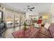 Beautiful living room with fireplace, ceiling fan, backyard views, and adjacent kitchen at 2715 Ivey Crossing Trl, Cumming, GA 30041