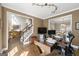 Inviting office featuring hardwood floors, natural light, and a view to the stairway at 2715 Ivey Crossing Trl, Cumming, GA 30041