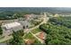 Aerial view showcasing a home nestled in a wooded area near commercial development, offering both seclusion and convenience at 2585 Braselton Hwy, Buford, GA 30519