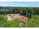 Aerial view of a serene property with a house, garage, and lush green surroundings at 2585 Braselton Hwy, Buford, GA 30519