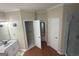 Bathroom with double doors, a double sink vanity, and a standing shower at 5700 Thrasher Sw Ln, Conyers, GA 30094