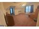 Attic bedroom with tan carpet, fan and natural light from multiple windows at 5700 Thrasher Sw Ln, Conyers, GA 30094