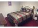 Comfortable bedroom with a gold colored metal bed frame and ornate bedding at 5700 Thrasher Sw Ln, Conyers, GA 30094