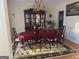Dining room with wooden floors and an elegant chandelier above a table set for dinner at 5700 Thrasher Sw Ln, Conyers, GA 30094