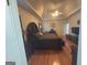 Main bedroom with dark furniture and a tray ceiling at 5700 Thrasher Sw Ln, Conyers, GA 30094