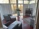 Bright sunroom with hardwood floors, wicker furniture, a leaf-patterned rug, and large windows offering natural light at 5700 Thrasher Sw Ln, Conyers, GA 30094