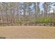 The spacious backyard features a black fence and views of the wooded area behind the home at 446 Bandon Way, Peachtree City, GA 30269