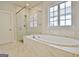 Bathroom features a soaking tub with marble surround and a glass enclosed shower at 446 Bandon Way, Peachtree City, GA 30269