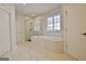 Bathroom features a soaking tub with marble surround and glass enclosed shower at 446 Bandon Way, Peachtree City, GA 30269