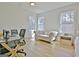 Sunlit workspace in the main bedroom features hardwood floors, natural light, and a comfortable sofa at 446 Bandon Way, Peachtree City, GA 30269
