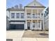 Charming two-story home with a welcoming front porch and a two-car garage, offers a blend of classic and modern architecture at 446 Bandon Way, Peachtree City, GA 30269