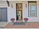 Charming home exterior featuring a brick walkway leading to the front door with potted flowers at 446 Bandon Way, Peachtree City, GA 30269