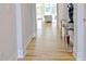 Hallway featuring light hardwood floors and stylish decorations on a console table at 446 Bandon Way, Peachtree City, GA 30269