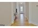 Hallway featuring light-colored walls, wood floors, and a stylish display table at 446 Bandon Way, Peachtree City, GA 30269