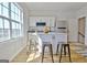 Bright kitchen area features an island with seating, stainless steel appliances, and a large window at 446 Bandon Way, Peachtree City, GA 30269