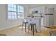 Bright kitchen area features an island with seating, stainless steel appliances, and a large window at 446 Bandon Way, Peachtree City, GA 30269