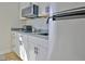 Bright kitchen features white cabinetry, stainless steel appliances, gray countertops, and subway tile backsplash at 446 Bandon Way, Peachtree City, GA 30269