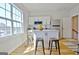 Bright kitchen area features an island with seating, stainless steel appliances, and a large window at 446 Bandon Way, Peachtree City, GA 30269