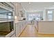 Updated kitchen with gray cabinets, stainless steel appliances, island with sink, and dining area nearby at 446 Bandon Way, Peachtree City, GA 30269