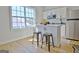 Bright kitchen area features an island with seating, stainless steel appliances, and a large window at 446 Bandon Way, Peachtree City, GA 30269