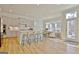 Modern kitchen with an island, barstool seating, and adjacent dining area bathed in natural light at 446 Bandon Way, Peachtree City, GA 30269