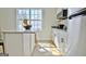 Bright kitchen area features an island with seating, stainless steel appliances, and a large window at 446 Bandon Way, Peachtree City, GA 30269