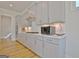 Modern kitchen features gray cabinets, stainless steel appliances, subway tile backsplash, and light wood floors at 446 Bandon Way, Peachtree City, GA 30269