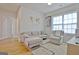 Cozy living area with light-colored sectional, chair, hardwood floors and a world map wall decoration at 446 Bandon Way, Peachtree City, GA 30269