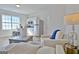Bright living space features an open kitchen, a large window, and modern furniture at 446 Bandon Way, Peachtree City, GA 30269