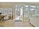 Open-concept room with dining area, living area with windows overlooking an outdoor patio at 446 Bandon Way, Peachtree City, GA 30269