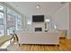 Bright living room with large windows, neutral decor, fireplace, and light hardwood floors at 446 Bandon Way, Peachtree City, GA 30269