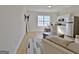 Open-concept living area with hardwood floors, island seating, and modern stainless steel appliances at 446 Bandon Way, Peachtree City, GA 30269