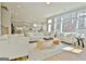 Bright living room with large windows, hardwood floors, and modern, comfortable white furniture at 446 Bandon Way, Peachtree City, GA 30269