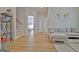 Living area with light-colored couch, hardwood floors, shelving and access to a bedroom at 446 Bandon Way, Peachtree City, GA 30269
