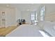Spacious main bedroom features hardwood floors, a sitting area, a work space, and ensuite bathroom access at 446 Bandon Way, Peachtree City, GA 30269