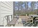 Outdoor patio features outdoor seating, an outdoor grill, and a view of the wooded backyard at 446 Bandon Way, Peachtree City, GA 30269