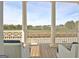 Covered porch features white columns, wood floors, and outdoor seating for relaxing at 446 Bandon Way, Peachtree City, GA 30269