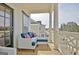 Relax on this covered porch with wood floors, white railings, and comfortable outdoor furniture at 446 Bandon Way, Peachtree City, GA 30269