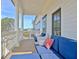 Enjoy this covered porch with wood floors, white columns, and comfortable outdoor lounge seating at 446 Bandon Way, Peachtree City, GA 30269