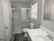Bathroom with a new sliding glass shower door, modern vanity, and neutral walls at 938 King James Dr, Morrow, GA 30260