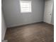 Cozy bedroom with wood flooring, natural light from the window, and neutral wall color at 938 King James Dr, Morrow, GA 30260