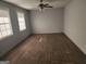 Spacious living room filled with natural light, wood-look flooring, and a modern ceiling fan at 938 King James Dr, Morrow, GA 30260
