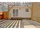 Back patio featuring a wooden pergola, wooden fence, and a sliding glass door to the home's interior at 1120 Minix Rd, Sharpsburg, GA 30277