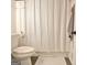 Bathroom with white tile, white toilet and a white shower curtain at 1120 Minix Rd, Sharpsburg, GA 30277