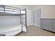 Bedroom with bunk beds, closet, hardwood floors, and dresser at 1120 Minix Rd, Sharpsburg, GA 30277