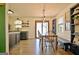 Dining room with hardwood floors, wood table, and chairs next to a kitchen area at 1120 Minix Rd, Sharpsburg, GA 30277